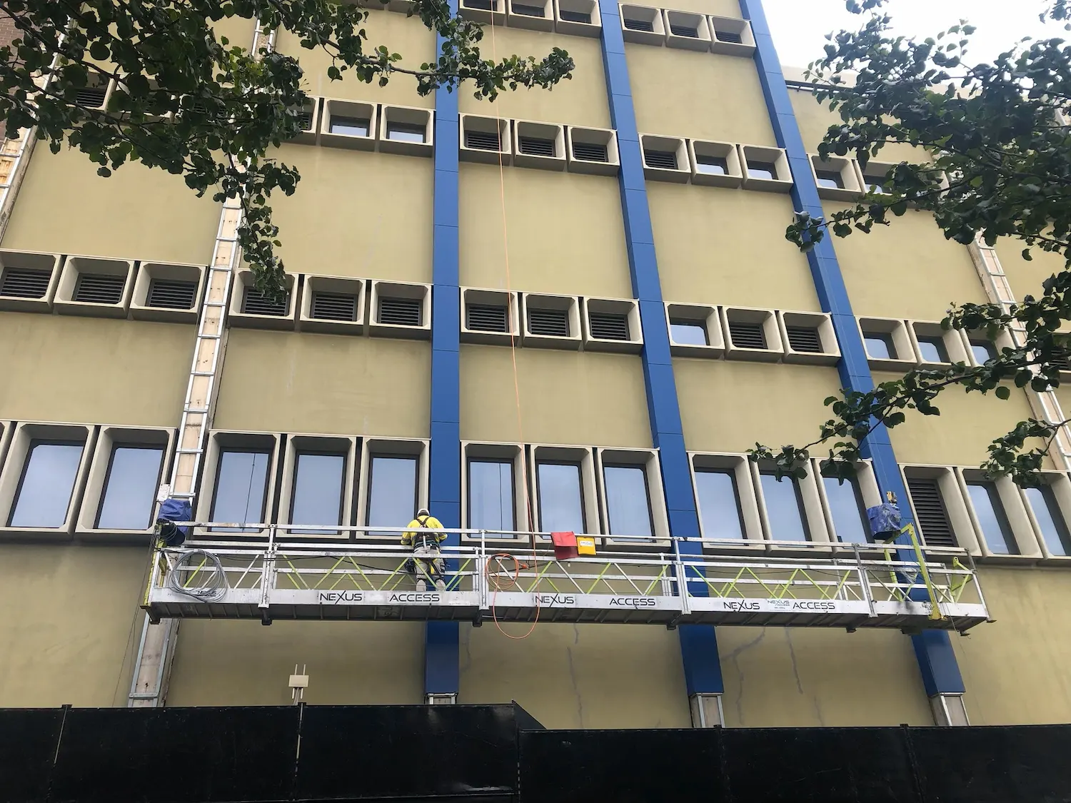 Swing stages on the facade of a multi-storey building during an Ikigai building upgrade